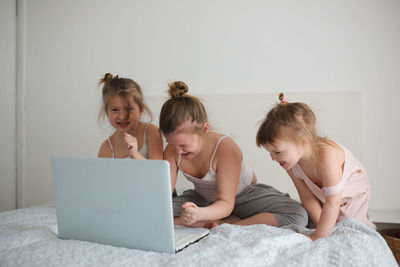 Girls are funny crazy kids argue over the laptop, the concept of childhood and gadgets, life style, 