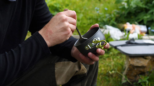 Midsection of man using mobile phone