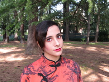 Portrait of mature man standing against trees