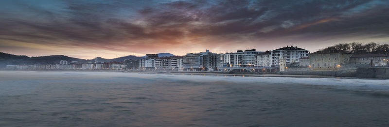 Scenic view of beach against dramatic sky