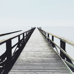 Pier over sea against clear sky
