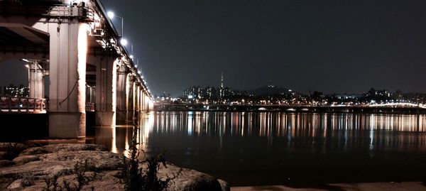 View of city waterfront lit up at night