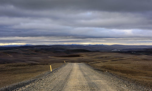 Empty road along countryside landscape