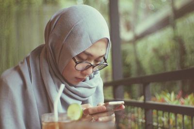 Midsection of man using mobile phone