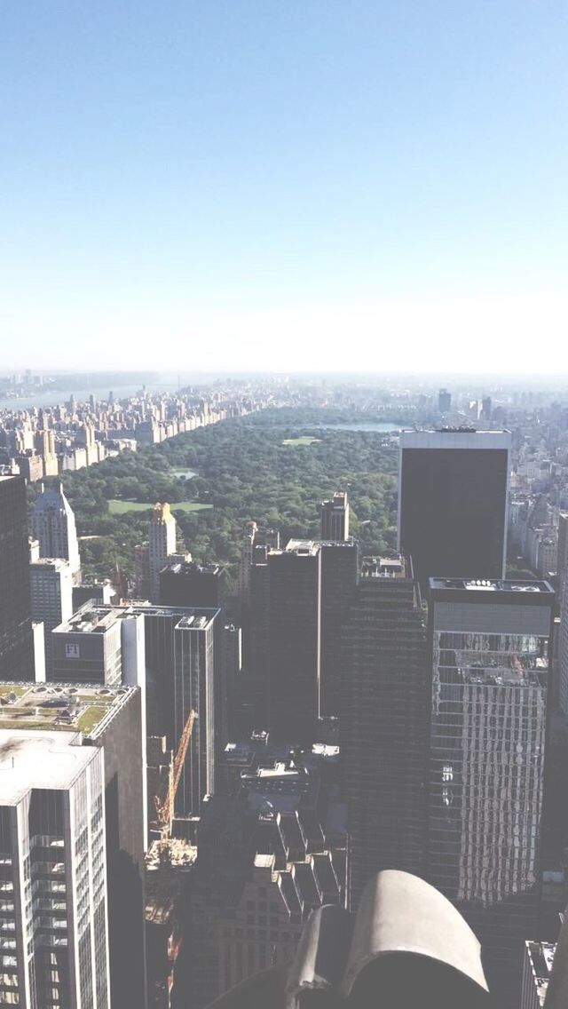 HIGH ANGLE VIEW OF CITYSCAPE AGAINST BLUE SKY