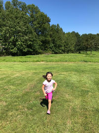 Full length of girl running on field