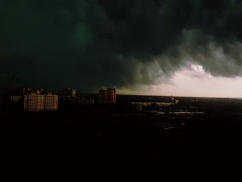 View of cityscape against storm clouds