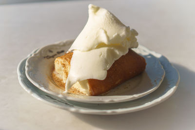 Bread with vanilla ice cream on plate