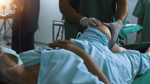 Midsection of doctor examining patient at clinic