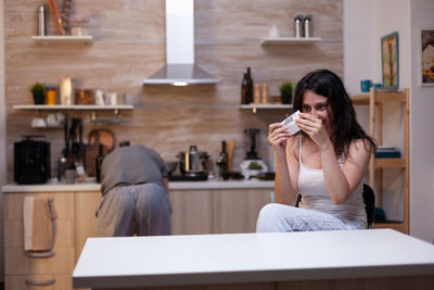 Young woman sitting on table