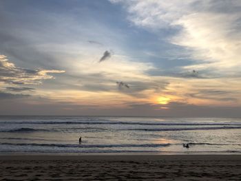 Scenic view of beach against sky during sunset