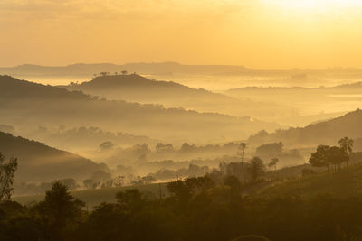 Scenic view of mountains against sky during sunrise