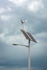 Low angle view of windmill against sky