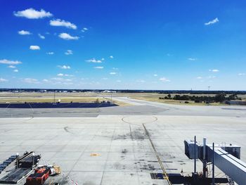 Airplane on airport runway against blue sky