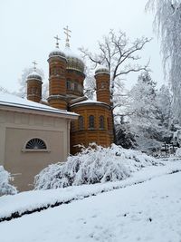 Snow covered temple against sky