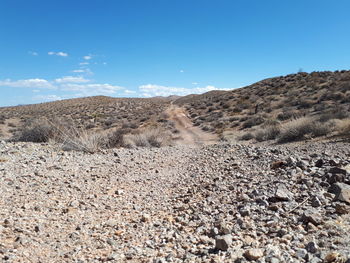 Scenic view of arid landscape against sky