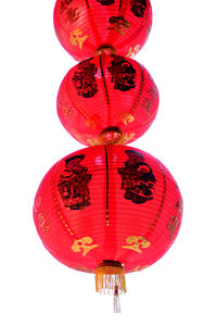 Low angle view of lantern hanging against white background