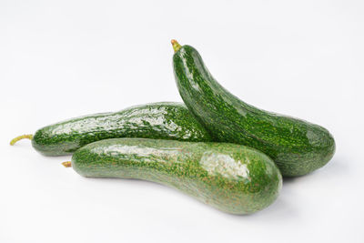 Close-up of green chili pepper against white background