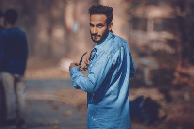 Portrait of young man standing outdoors