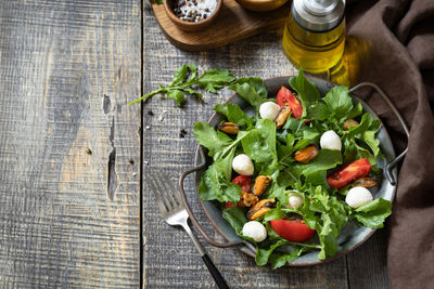 Healthy diet salad with arugula, mozzarella, mussels and vinaigrette dressing. low calories 
