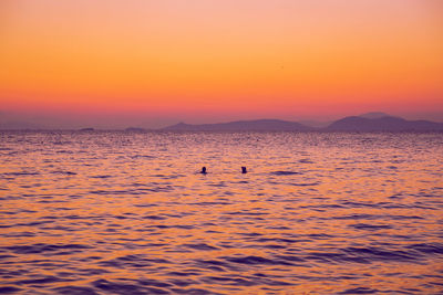 Scenic view of sea against orange sky