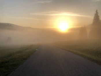 Scenic view of road against sky during sunset