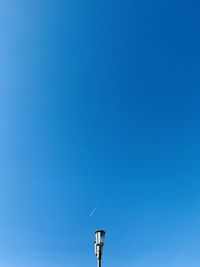 Low angle view of street light against clear blue sky