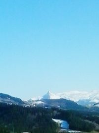 Scenic view of mountains against clear blue sky