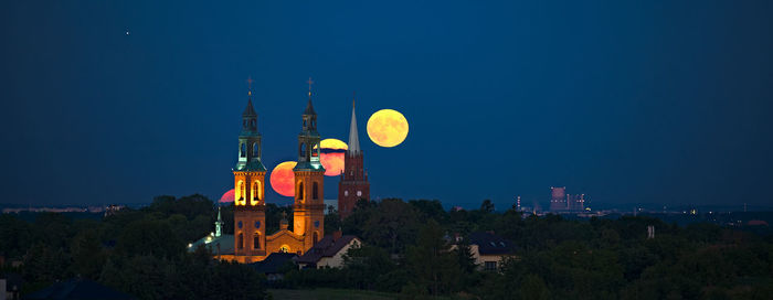 View of illuminated buildings against sky at night