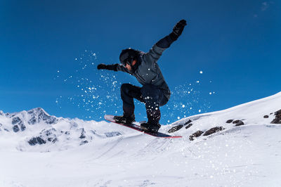 Full length of man skiing on snow covered landscape