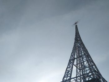 Low angle view of communications tower against sky