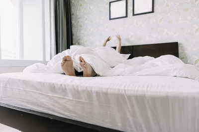 White sleeping on bed in bedroom