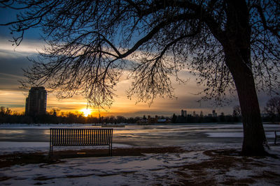 Scenic view of frozen lake against sky during sunset