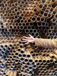 Paper cardboard cilinders piled up with a hand in front 