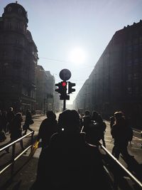 People on street in city against clear sky