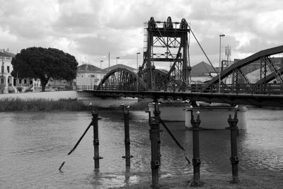 View of bridge over river against cloudy sky