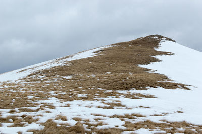 Snow covered mountain against sky