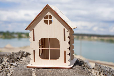 Close-up of house on beach against sky