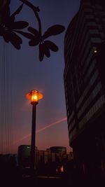 Low angle view of illuminated skyscraper against sky at night