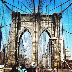 Low angle view of brooklyn bridge against sky during sunny day