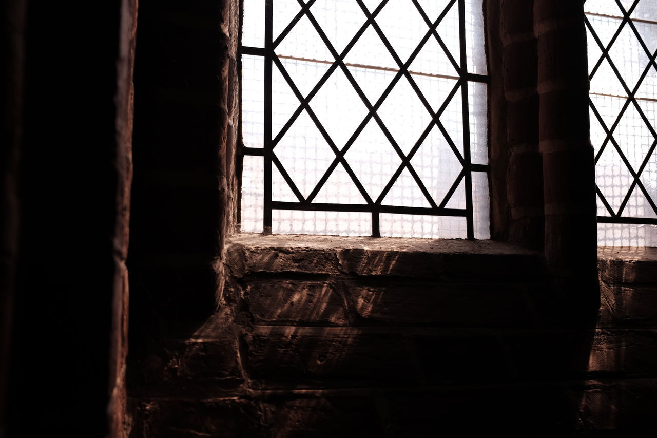 DAMAGED WINDOW IN ABANDONED ROOM