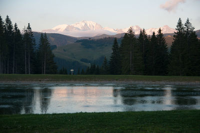 Scenic view of lake and mountains against sky