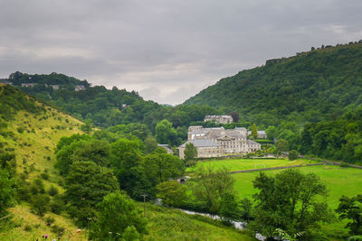 Scenic view of trees and buildings against sky