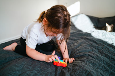 High angle view of woman relaxing on bed at home