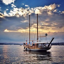 Sailboat in sea at sunset