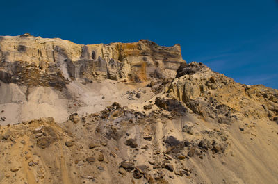 Low angle view of rock formations against sky