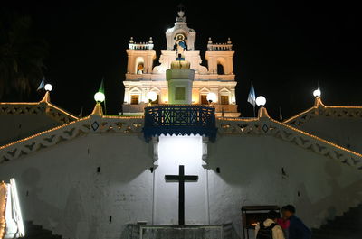 Illuminated building against sky at night