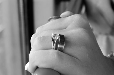 Close-up of woman wearing engagement rings