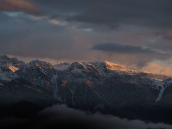 Scenic view of snowcapped mountains against sky during sunset