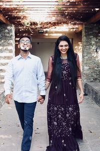 Portrait of young couple standing outdoors